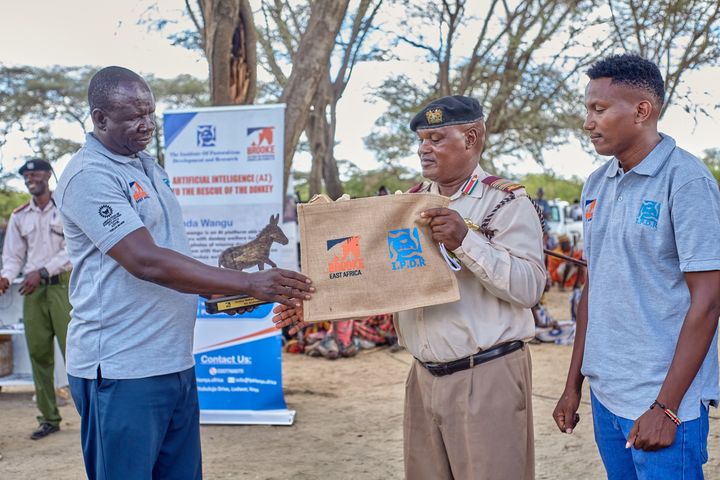 Presenting a gift bag and donkey sculpture at the event