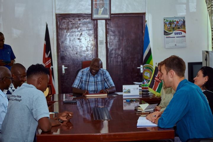 A meeting with local leadership and visiting partners